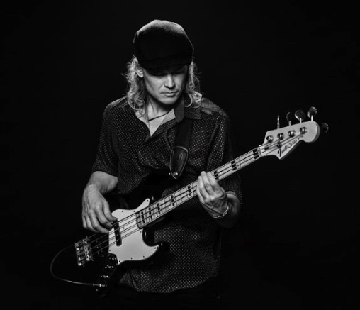 Bass Gutiar playing starring at gutair while playing in black and white